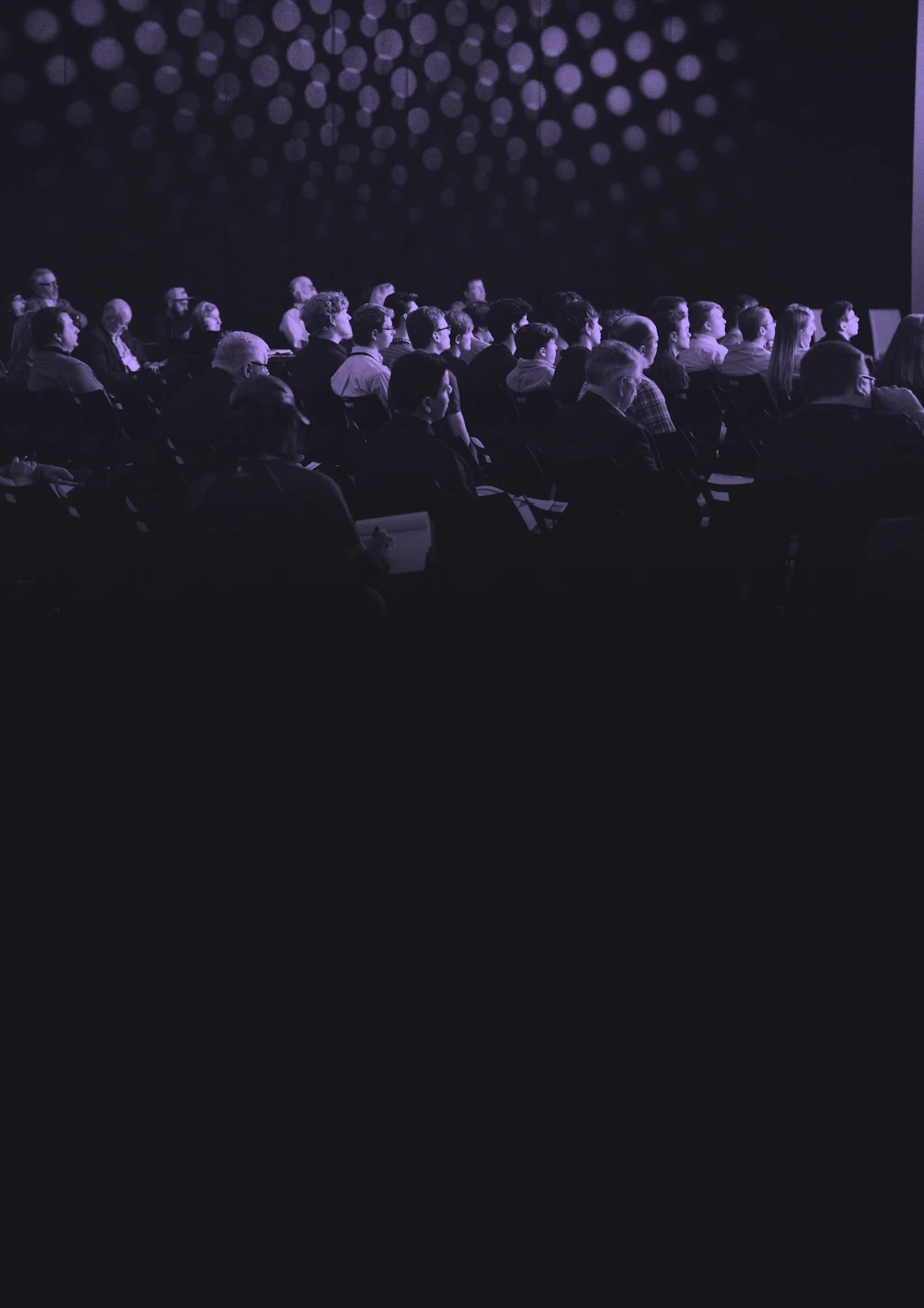 An audience gathered in a conference room, from The Whole Room whitepaper