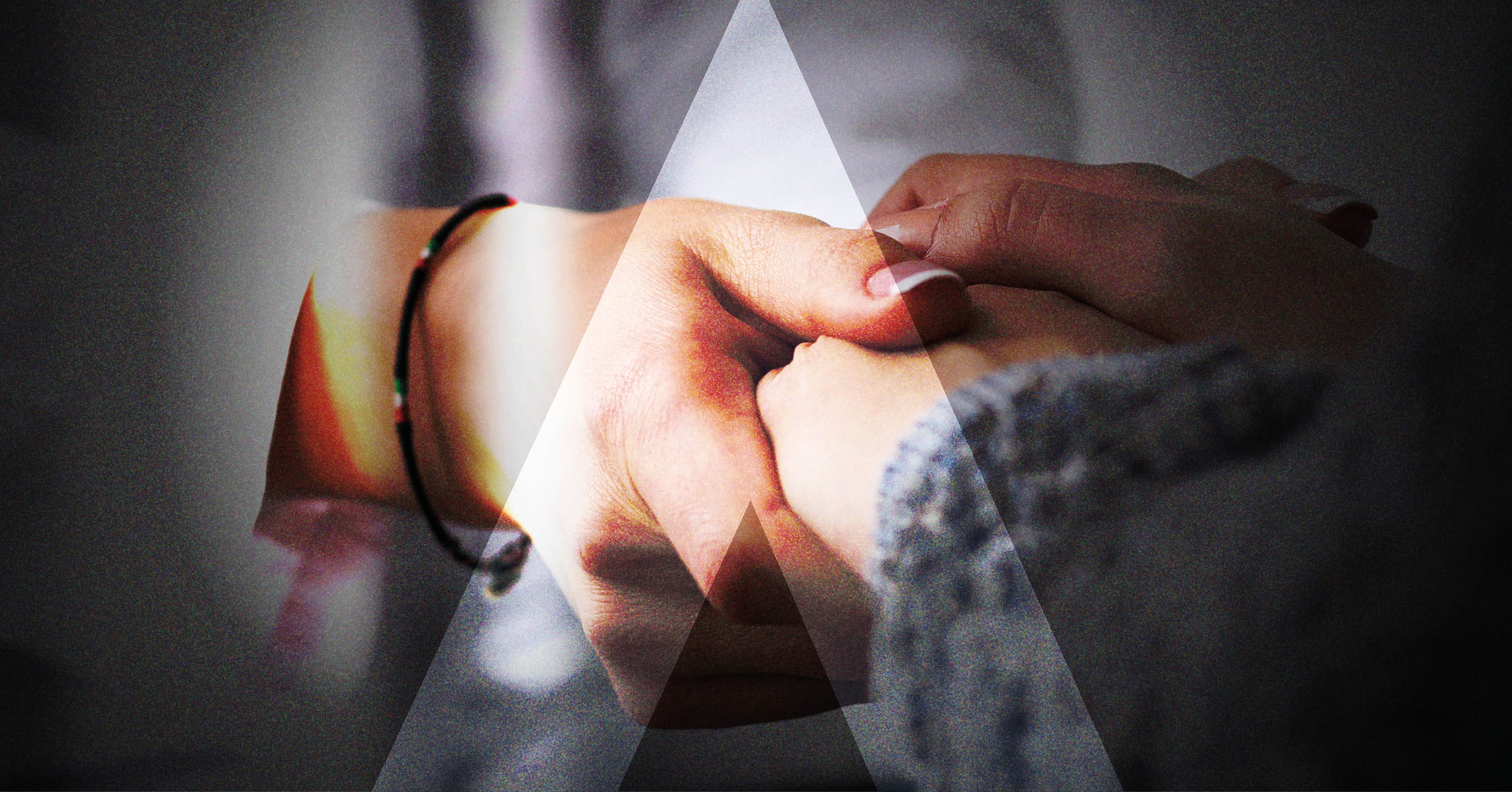 Two hands held together in a care setting, representing the trust mapped across NHS stakeholders