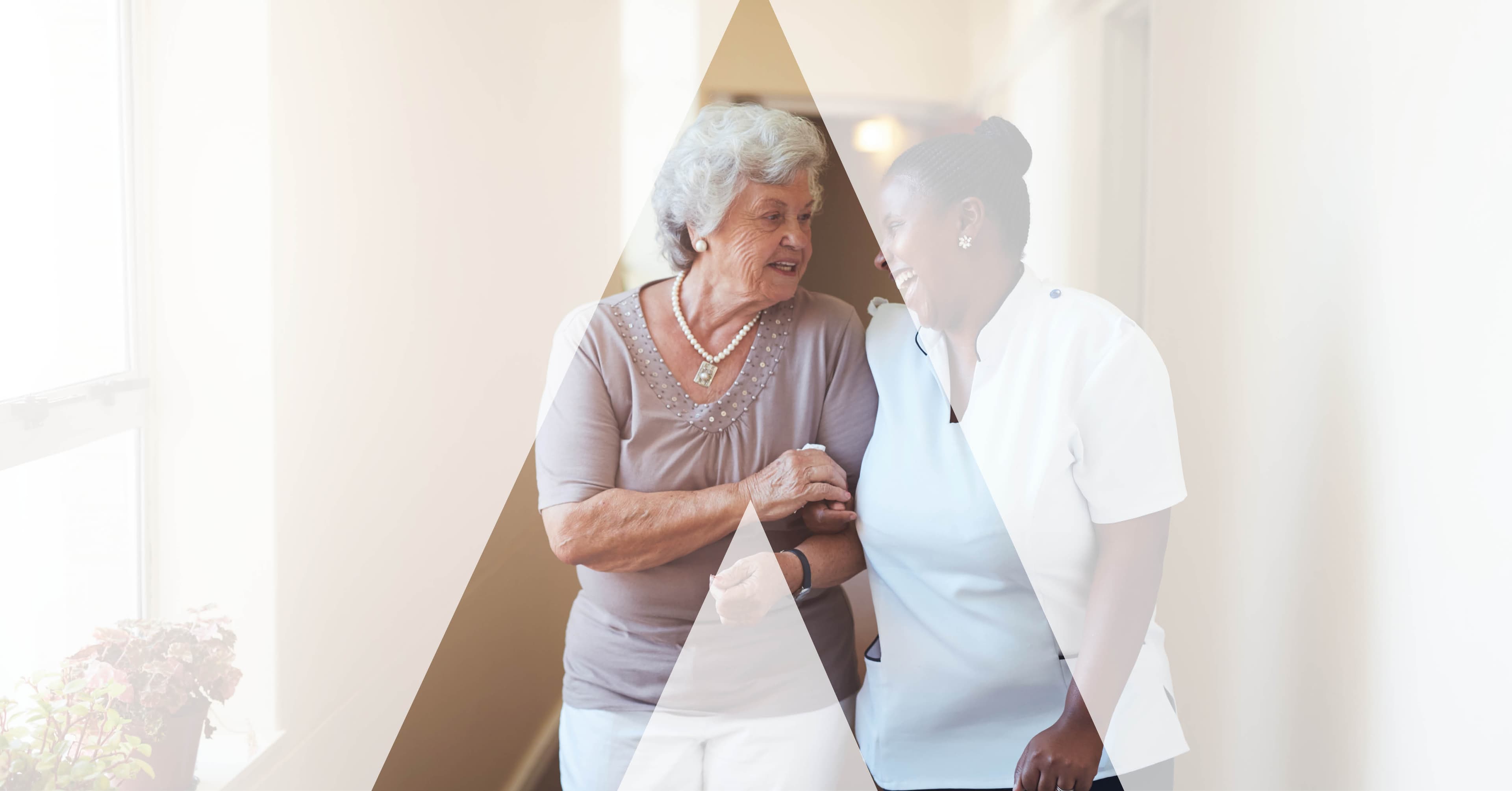 A nurse supporting an older patient by a bright window, the care setting a launched product has to reach